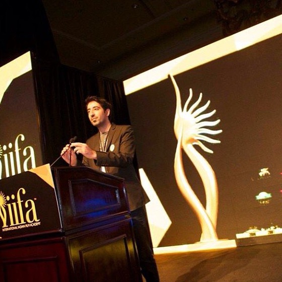 Kaiser Khan speaking on stage at the IIFA Awards
